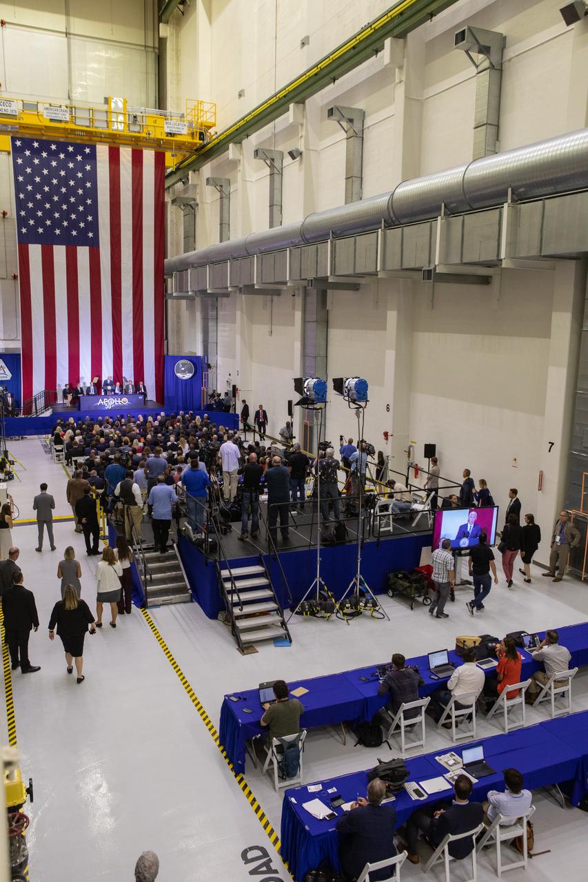 In this view photographed from above, Vice President Mike Pence addresses invited guests, elected officials and NASA, Lockheed Martin and other industry leaders at Kennedy Space Center’s Neil Armstrong Operations & Checkout Building on July 20, 2019. Pence, who visited the Florida spaceport in honor of the 50th anniversary of the Apollo 11 mission, also spoke about NASA’s progress and future plans to return to the Moon and on to Mars. 