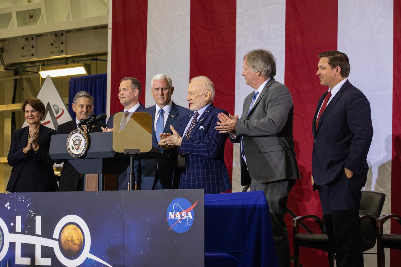 Vice President Mike Pence, fourth from left, addresses invited guests, elected officials and NASA, Lockheed Martin and other industry leaders at Kennedy Space Center’s Neil Armstrong Operations & Checkout Building on July 20, 2019. Pence, who visited the Florida spaceport in honor of the 50th anniversary of the Apollo 11 mission, also spoke about NASA’s progress and future plans to return to the Moon and on to Mars. Others with him are, from left, Lockheed Martin Chairwoman, President and CEO Marilyn Hewson; Bob Cabana, Kennedy Space Center director; NASA Administrator Jim Bridenstine; Apollo 11 Lunar Module Pilot Buzz Aldrin; Rick Armstrong, son of Apollo 11 Commander Neil Armstrong; and Florida Governor Ron DeSantis.