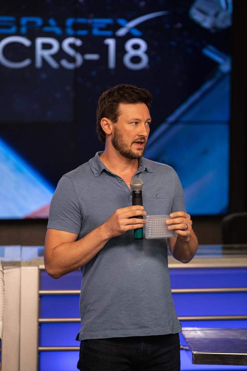 Andres Bratt-Leal, Ph.D., of Aspen Neuroscience, talks to NASA Social participants during a What’s On Board science briefing at the agency’s Kennedy Space Center in Florida on July 23, 2019. Bratt-Leal is a principal investigator for the Effects of Microgravity on Microglia 3-Dimensional Models of Parkinson’s Disease and Multiple Sclerosis (Space Tango-Induced Pluripotent Stem Cells) payload. The briefing was held for SpaceX’s 18th Commercial Resupply Services (CRS-18) mission to the International Space Station. The SpaceX Falcon 9 rocket and uncrewed Dragon spacecraft are scheduled to launch July 24, 2019, from Space Launch Complex 40 at Florida’s Cape Canaveral Air Force Station.