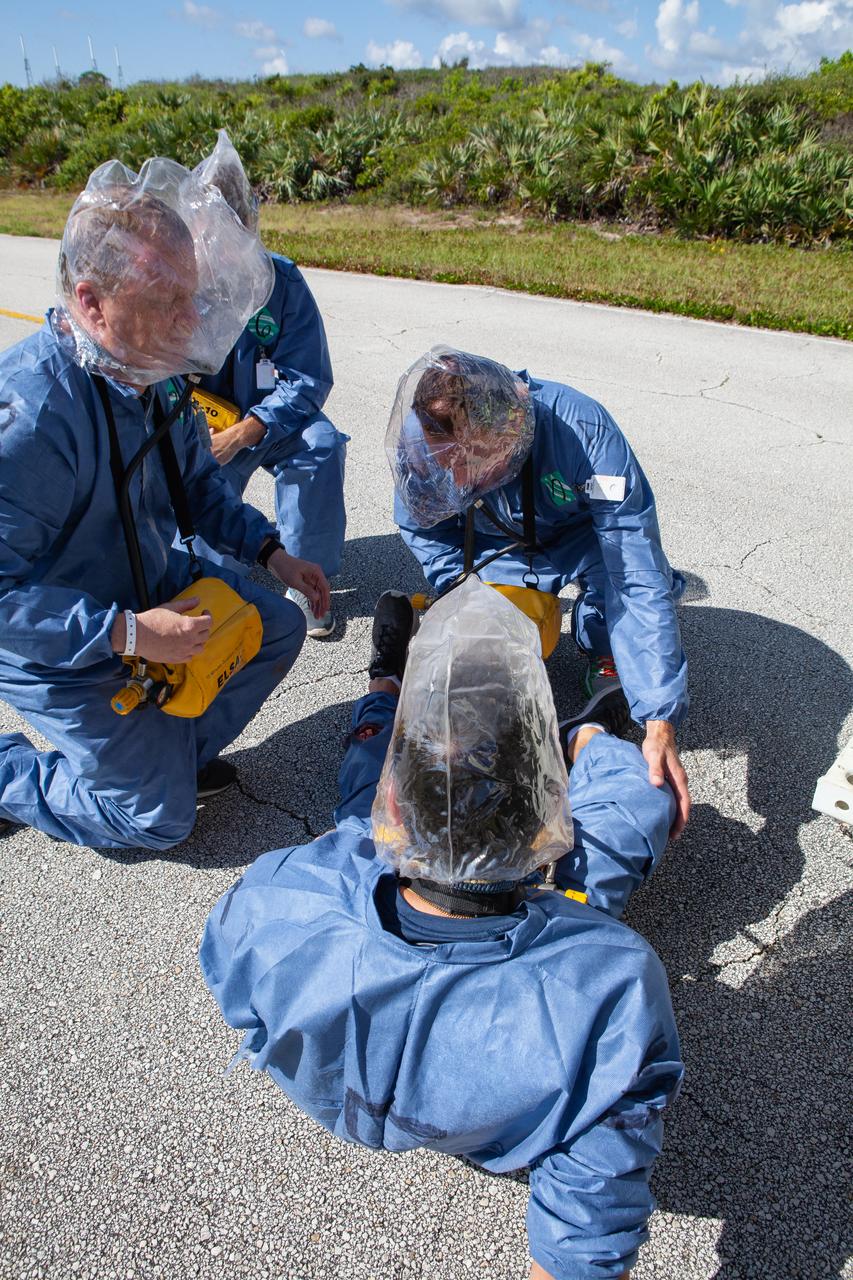 Wearing portable respirators, astronauts with simulated injuries participate in a joint emergency escape and triage simulation led by NASA, along with Boeing and United Launch Alliance, at Space Launch Complex 41 at Cape Canaveral Air Force Station in Florida on July 24, 2019. The simulation is one in a series in preparation for upcoming crew flights to the International Space Station as part of NASA’s Commercial Crew Program.  NASA astronauts Josh Cassada, currently in training for the second flight with crew aboard Boeing’s CST-100 Starliner spacecraft, and Eric Boe, along with astronaut candidate Jasmin Moghbeli, served as the flight crew. The astronauts practiced emergency egress from the nearly 200-foot-tall crew access tower at the launch pad. They also rehearsed escape from the launch complex in an armored vehicle, and decontamination and triage at a nearby helipad.