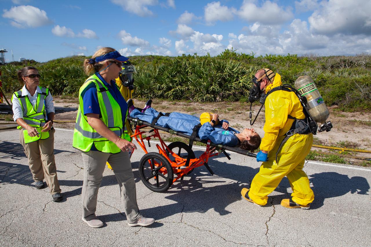 Astronaut candidate Jasmin Moghbeli is placed on a stretcher due to a simulated injury during a joint emergency escape and triage exercise led by NASA, along with Boeing and United Launch Alliance, at Space Launch Complex 41 at Cape Canaveral Air Force Station in Florida on July 24, 2019. The simulation is one in a series in preparation for upcoming crew flights to the International Space Station as part of NASA’s Commercial Crew Program.  NASA astronauts Josh Cassada, currently in training for the second flight with crew aboard Boeing’s CST-100 Starliner spacecraft, and Eric Boe, along with Moghbeli, served as the flight crew. The astronauts practiced emergency egress from the nearly 200-foot-tall crew access tower at the launch pad. They also rehearsed escape from the launch complex in an armored vehicle, and decontamination and triage at a nearby helipad.