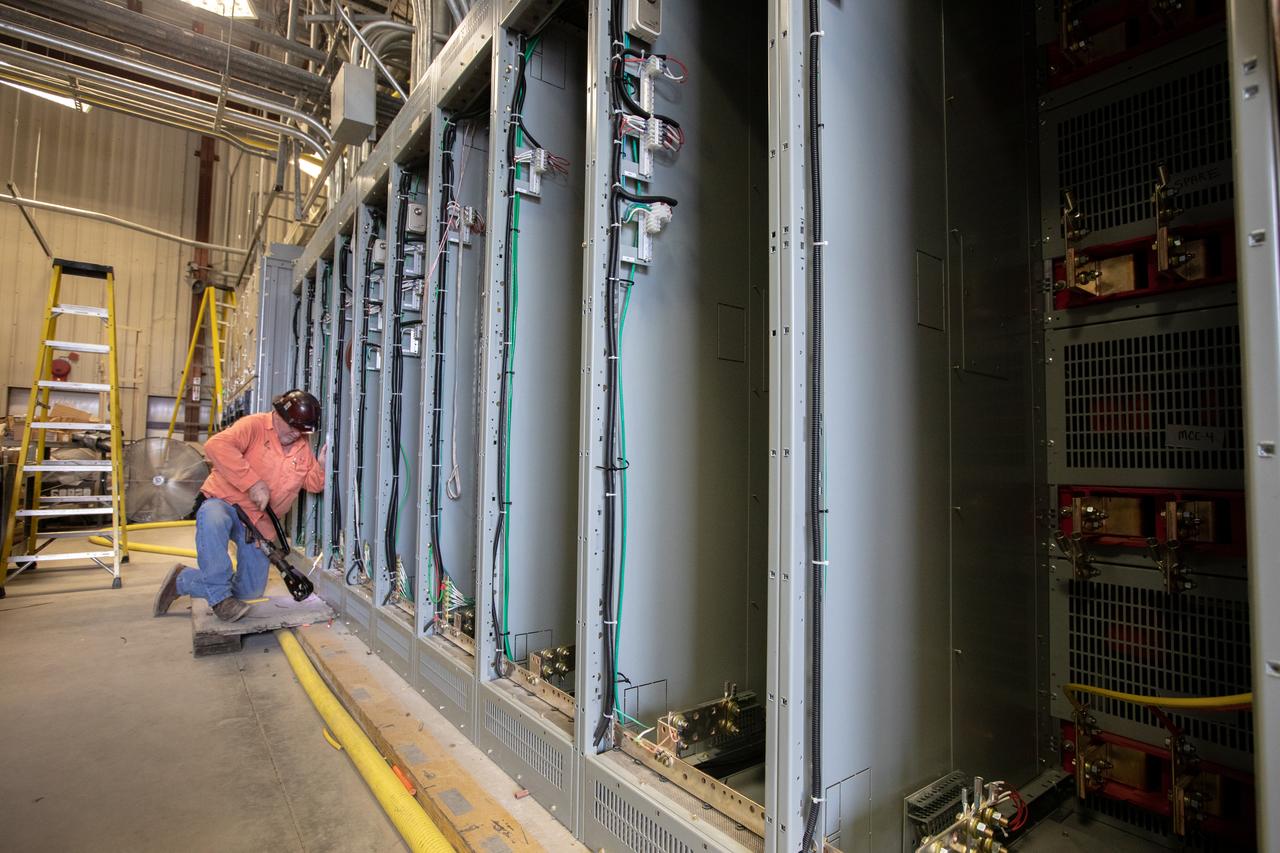 A construction worker installs new wiring inside the Utility Annex near the Vehicle Assembly (VAB) Building at NASA’s Kennedy Space Center in Florida on July 24, 2019. The Utility Annex, which provides 8,000 gallons of chilled water per minute to the VAB and other facilities in the Launch Complex 39 area, is being upgraded and repaired. The facility also contains boilers necessary to provide hot water to the VAB. The center’s Engineering Directorate is making the repairs and upgrades to the facility to prepare for the agency’s Artemis missions to the Moon and on to Mars.