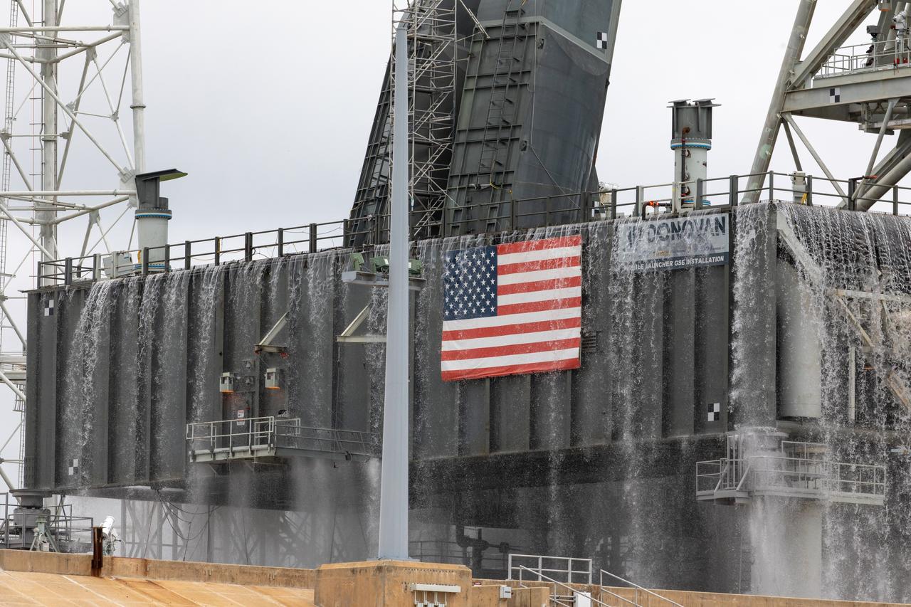 A flow test of the Ignition Overpressure Protection and Sound Suppression water deluge system is underway on the mobile launcher at Launch Pad 39B at NASA's Kennedy Space Center in Florida, on July 25, 2019. The testing is part of a series of tests that Exploration Ground System is doing to verify the system is ready for the new Space Launch System rocket. Modifications were made to the pad after a previous wet flow test, increasing the performance of the system. During the launch of Artemis 1 and subsequent missions, this water deluge system will release about 450,000 gallons of water across the mobile launcher and Flame Deflector to reduce the extreme heat and energy generated by the rocket during ignition and liftoff.