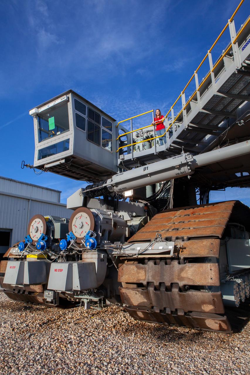 Breanne Stichler, mechanical engineer I, stands atop NASA’s Crawler-Transporter 2 (CT-2) at the Kennedy Space Center in Florida on Aug. 8, 2019. Stichler started working at Kennedy in June and is among one of the few females to have ever driven the crawler. CT-2 will carry the agency’s mobile launcher with the Space Launch System rocket from the Vehicle Assembly Building to Launch Pad 39B for the launch of Artemis 1, the first in a series of complex missions that will provide the foundation for human deep space exploration. 