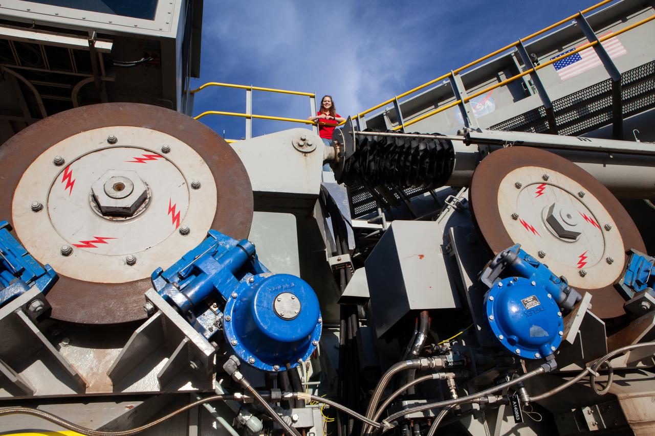 Breanne Stichler, mechanical engineer I, is photographed atop NASA’s Crawler-Transporter 2 (CT-2) at the Kennedy Space Center in Florida on Aug. 8, 2019. Stichler started working at Kennedy in June and is among one of the few females to have ever driven the crawler. CT-2 will carry the agency’s mobile launcher with the Space Launch System rocket from the Vehicle Assembly Building to Launch Pad 39B for the launch of Artemis 1, the first in a series of complex missions that will provide the foundation for human deep space exploration. 