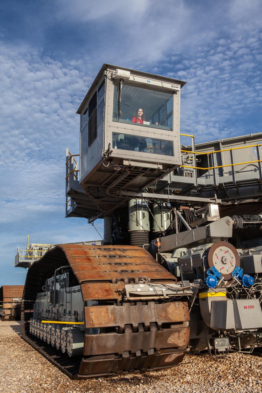 Breanne Stichler, mechanical engineer I, is photographed inside the cab of NASA’s Crawler-Transporter 2 (CT-2) at the Kennedy Space Center in Florida on Aug. 8, 2019. Stichler started working at Kennedy in June and is among one of the few females to have ever driven the crawler. CT-2 will carry the agency’s mobile launcher with the Space Launch System rocket from the Vehicle Assembly Building to Launch Pad 39B for the launch of Artemis 1, the first in a series of complex missions that will provide the foundation for human deep space exploration. 