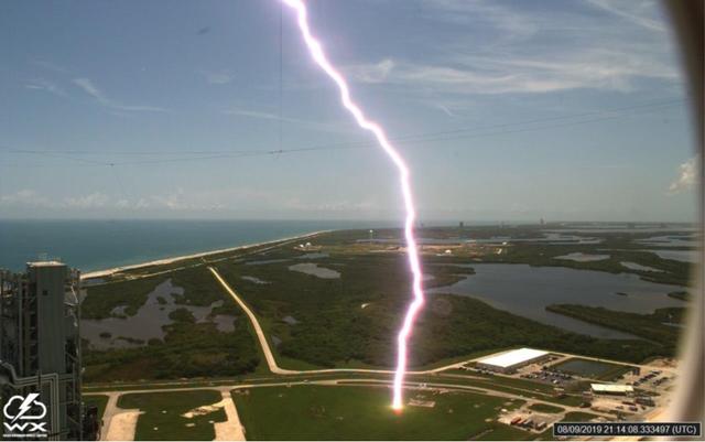 A lightning strike is recorded at Launch Complex 39B at NASA’s Kennedy Space Center in Florida in August 2019. The event was captured by high-speed cameras stationed at the pad and mobile launcher using a special filter called a “clear day frame,” which provides an overlay of the raw frame on a reference image. At pad 39B, there are three, 600-foot-tall masts with overhead wires used to transmit electrical energy around the perimeter of the pad to provide lightning protection for launch vehicles as they are processed and launched from the pad.