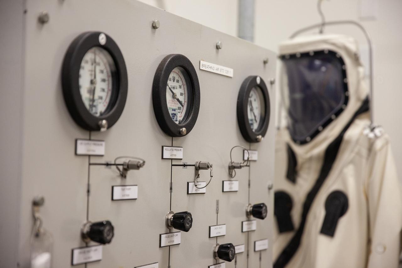 Inside the Multi-Operations Support Building near the Multi-Payload Processing Facility (MPPF) at NASA’s Kennedy Space Center in Florida on Aug. 16, 2019, a Self-Contained Atmospheric Protective Ensemble (SCAPE) suit is in view inside a changing room. SCAPE technicians are practicing putting on SCAPE suits and preparing for a test simulation of loading propellants into a replicated test tank for Orion. Exploration Ground Systems is preparing for Artemis 1 with a series of hazardous hyper test events at the MPPF. After donning their suits, the technicians will complete a tanking to test the system before Orion arrives for processing. During preparations for launch, these teams will be responsible for loading the Orion vehicle with propellants prior to transportation to the Vehicle Assembly Building, where it will be secured atop the Space Launch System rocket. SCAPE suits are used in operations involving toxic propellants and are supplied with air either through a hardline or through a self-contained environmental control unit.