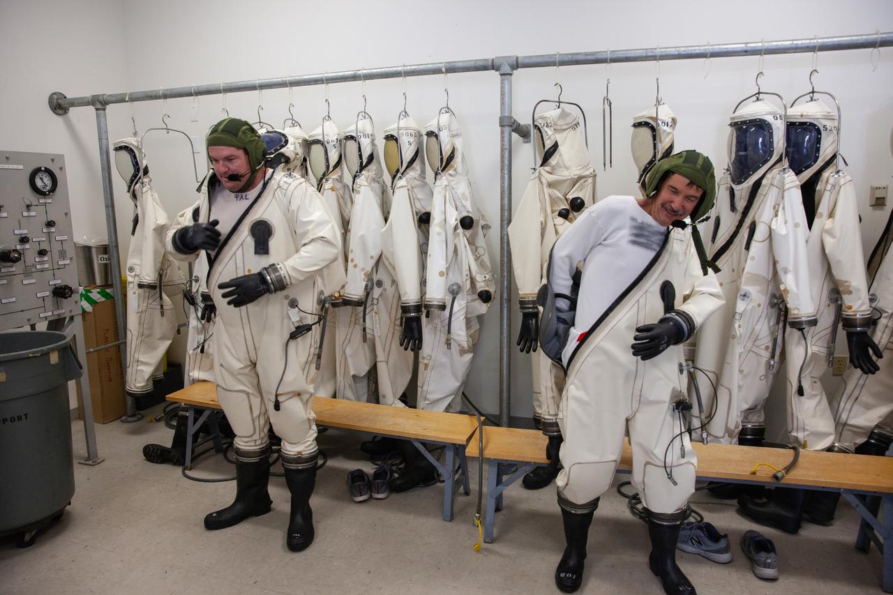 Inside the Multi-Operations Support Building near the Multi-Payload Processing Facility (MPPF) at NASA’s Kennedy Space Center in Florida, technicians put on Self-Contained Atmospheric Protective Ensemble (SCAPE) suits inside a changing room on Aug. 16, 2019. SCAPE technicians are practicing putting on the suits for a test simulation of loading propellants into a replicated test tank for Orion. Exploration Ground Systems is preparing for Artemis 1 with a series of hazardous hyper test events at the MPPF. After donning their suits, the technicians will complete a tanking to test the system before Orion arrives for processing. During preparations for launch, these teams will be responsible for loading the Orion vehicle with propellants prior to transportation to the Vehicle Assembly Building, where it will be secured atop the Space Launch System rocket. SCAPE suits are used in operations involving toxic propellants and are supplied with air either through a hardline or through a self-contained environmental control unit.