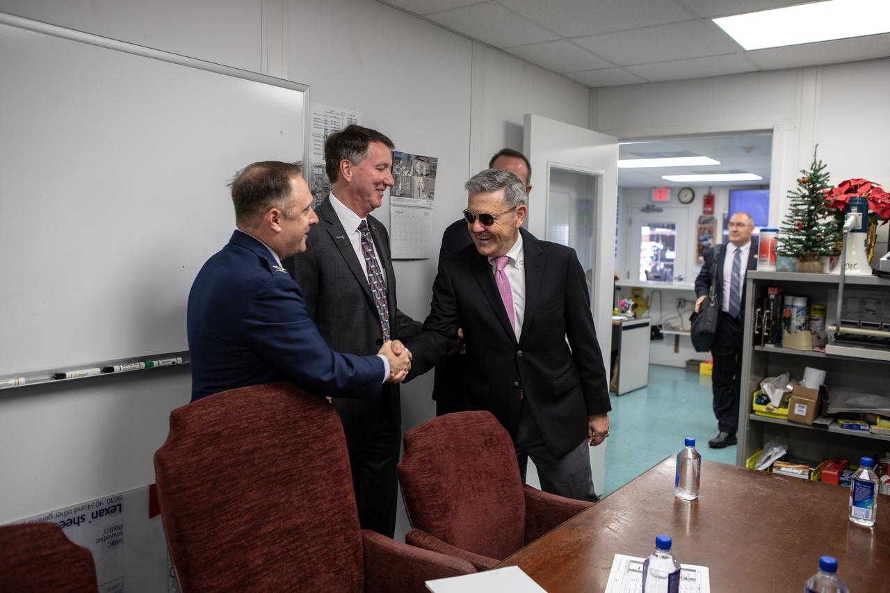 Just before a ribbon cutting ceremony on Aug. 16, 2019, in High Bay 2 of the Vehicle Assembly (VAB) at NASA’s Kennedy Space Center in Florida, Center Director Bob Cabana, at right, shakes hands with Col. Thomas Ste. Marie, vice commander, U.S. Air Force, 45th Space Wing. In the center is Kent Rominger, Northrop Grumman’s vice president and capture lead for the OmegA launch system. The VAB is getting its first commercial tenant. Northrop Grumman signed a Reimbursable Space Act Agreement with NASA for use of the facilities. The company will assemble and test its new OmegA rocket inside the massive facility’s High Bay 2. The company also will modify the space shuttle-era mobile launcher platform-3 to serve as the launch vehicle’s assembly and launch platform. Northrop Grumman is developing the OmegA rocket, an intermediate/heavy-class launch vehicle, as part of a launch services agreement with the U.S. Air Force.