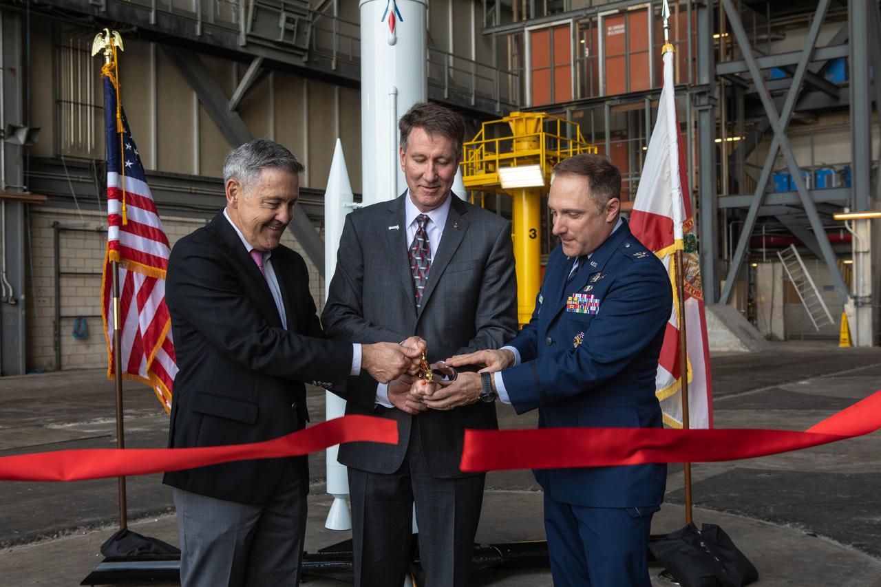 A ribbon cutting ceremony took place on Aug. 16, 2019, in High Bay 2 of the Vehicle Assembly Building (VAB) at NASA’s Kennedy Space Center in Florida. From left are Kennedy Center Director Bob Cabana; Kent Rominger, Northrop Grumman’s vice president and capture lead for the OmegA launch system; and Col. Thomas Ste. Marie, vice commander, U.S. Air Force, 45th Space Wing. Behind them is a scale model of the OmegA launch system. The VAB is getting its first commercial tenant. Northrop Grumman signed a Reimbursable Space Act Agreement with NASA for use of the facilities. The company will assemble and test its new OmegA rocket inside the massive facility’s High Bay 2. The company also will modify mobile launcher platform-3 to serve as the launch vehicle’s assembly and launch platform. Northrop Grumman is developing the OmegA rocket, an intermediate/heavy-class launch vehicle, as part of a launch services agreement with the U.S. Air Force.