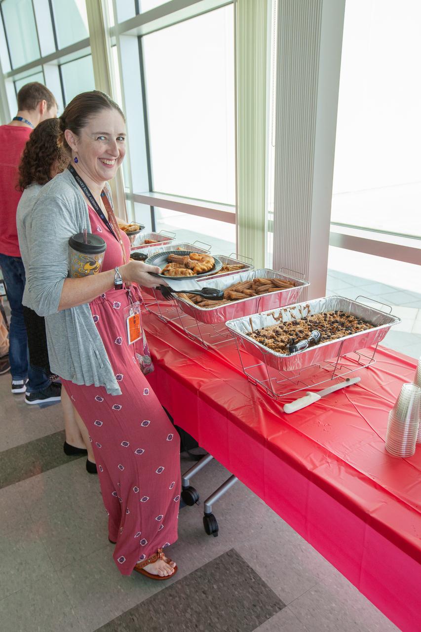 Kennedy Space Center employees sample food at the “KSC and Proud to Be” centerwide diversity event held at the Florida spaceport’s Operations Support Building II (OSB II) on Aug. 20, 2019. The event featured a presentation by Robin Hauser, a director and producer of award-winning documentaries. Hauser, who has spoken at the White House and at conferences worldwide, addressed bias in artificial intelligence. A new employee video focusing on the importance of employee resource groups at the center made its debut showing at the event.