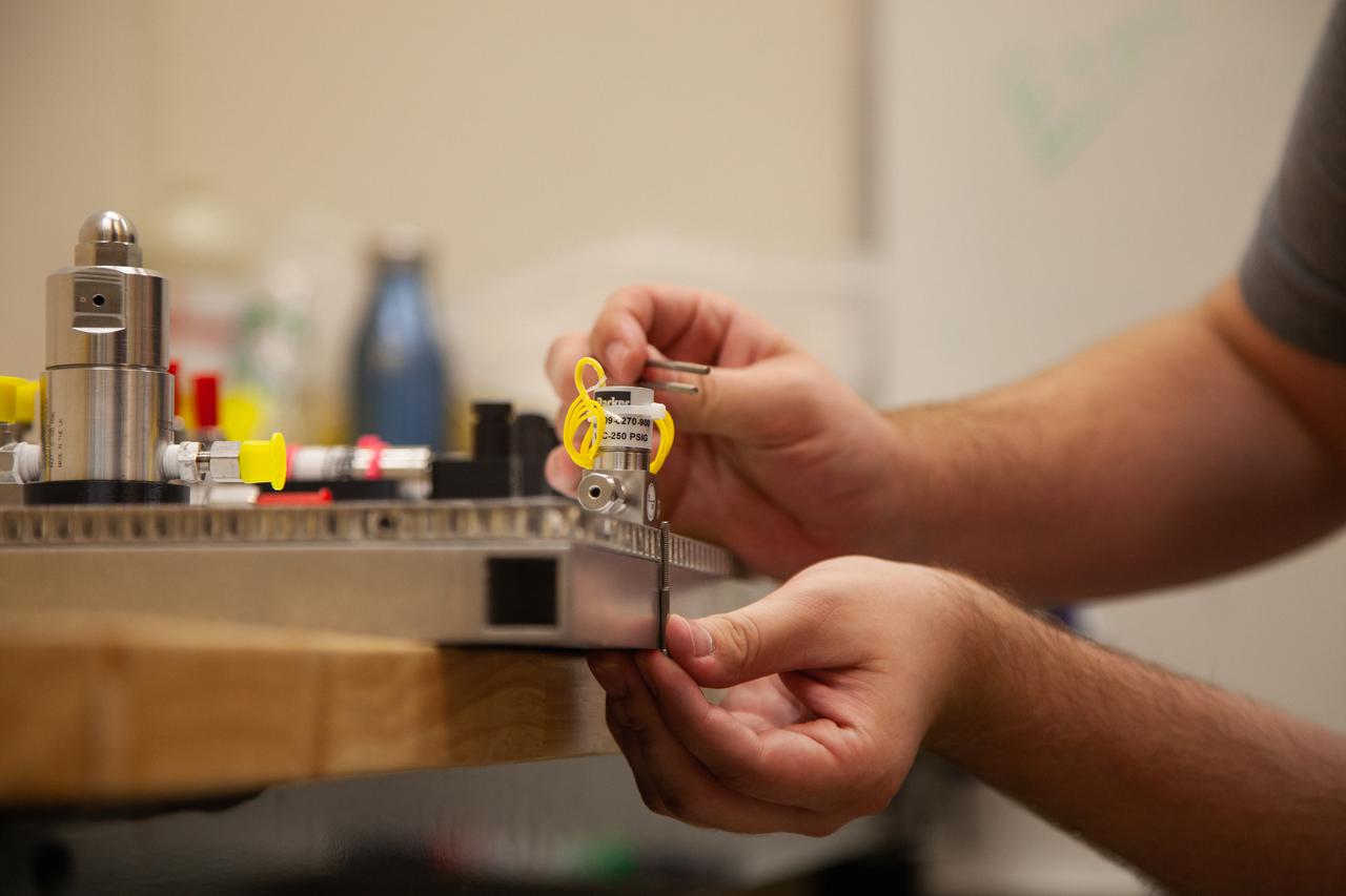 A Kennedy Space Center employee works on assembling the flight hardware of NASA’s Orbital Syngas Commodity Augmentation Reactor, or OSCAR – an Early Career Initiative project at the Florida spaceport that studies technology to convert trash and human waste into useful gasses such as methane, hydrogen and carbon dioxide. By processing small pieces of trash in a high-temperature reactor, OSCAR is advancing new and innovative technology for managing waste in space. OSCAR would reduce the amount of space needed for waste storage within a spacecraft, turn some waste into gasses that have energy storage and life support applications and ensure waste is no longer biologically active. A prototype has already been developed, and a team of Kennedy employees are in the process of constructing a new rig for suborbital flight testing. 