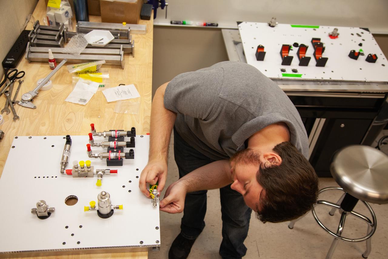 A Kennedy Space Center employee works on assembling the flight hardware of NASA’s Orbital Syngas Commodity Augmentation Reactor, or OSCAR – an Early Career Initiative project at the Florida spaceport that studies technology to convert trash and human waste into useful gasses such as methane, hydrogen and carbon dioxide. By processing small pieces of trash in a high-temperature reactor, OSCAR is advancing new and innovative technology for managing waste in space. OSCAR would reduce the amount of space needed for waste storage within a spacecraft, turn some waste into gasses that have energy storage and life support applications and ensure waste is no longer biologically active. A prototype has already been developed, and a team of Kennedy employees are in the process of constructing a new rig for suborbital flight testing. 