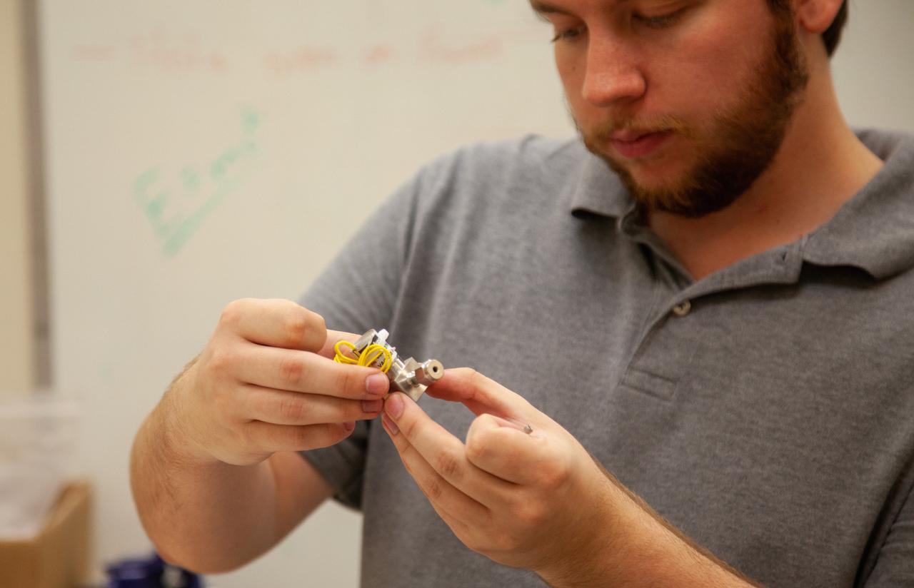 A Kennedy Space Center employee works on assembling the flight hardware of NASA’s Orbital Syngas Commodity Augmentation Reactor, or OSCAR – an Early Career Initiative project at the Florida spaceport that studies technology to convert trash and human waste into useful gasses such as methane, hydrogen and carbon dioxide. By processing small pieces of trash in a high-temperature reactor, OSCAR is advancing new and innovative technology for managing waste in space. OSCAR would reduce the amount of space needed for waste storage within a spacecraft, turn some waste into gasses that have energy storage and life support applications and ensure waste is no longer biologically active. A prototype has already been developed, and a team of Kennedy employees are in the process of constructing a new rig for suborbital flight testing. 