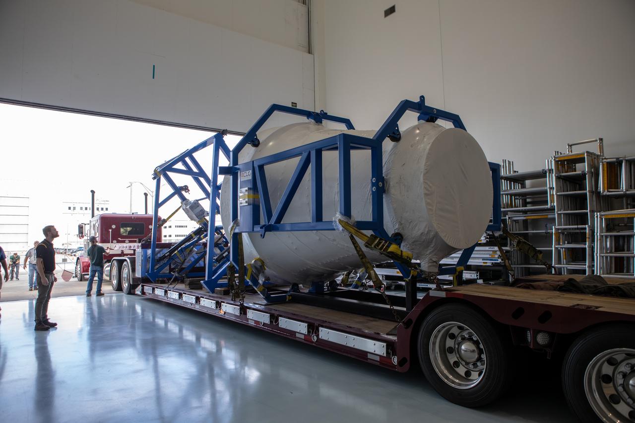 A truck carrying the cargo logistics module for Sierra Nevada Corporation’s Dream Chaser, the company’s reusable spaceplane, enters the Space Station Processing Facility high bay at NASA’s Kennedy Space Center in Florida on Aug. 27, 2019. The cargo module – a 15-foot attachment to Dream Chaser – provides extra storage for payloads and provides cargo disposal upon re-entry into Earth’s atmosphere. Dream Chaser will deliver more than 12,000 pounds of cargo to the International Space Station under the agency’s Commercial Resupply Services 2 contract. The spacecraft and cargo module will begin resupply and return services missions to the space station in late 2021. 