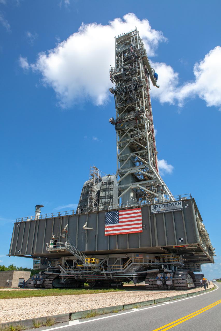 NASA’s mobile launcher (ML) atop crawler-transporter 2 moves along the crawlerway on Sept. 10, 2019, after spending a week and a half inside the Vehicle Assembly Building (VAB) at Kennedy Space Center in Florida due to the approach of Hurricane Dorian. The nearly 400-foot-tall structure was moved from Launch Pad 39B to the VAB for safekeeping on Aug. 30. The storm passed about 70 miles east of the spaceport during the overnight hours Tuesday, Sept. 3, and Wednesday, Sept. 4. NASA’s Exploration Ground Systems is moving the mobile launcher back to the launch pad, where teams will complete testing and checkout on the launcher in the coming weeks for the Artemis I mission.