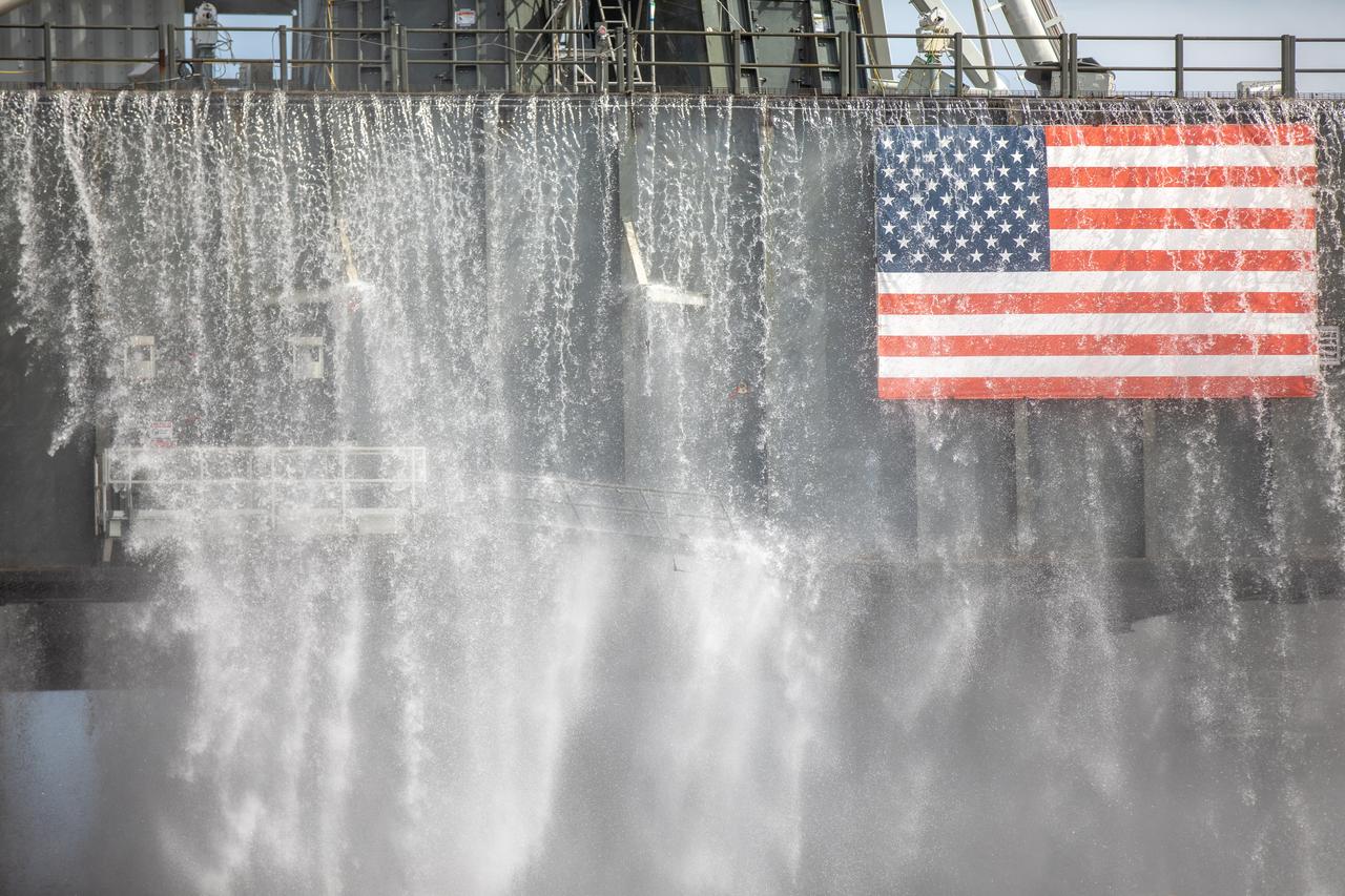 A wet flow test at Launch Pad 39B on September 13, 2019, tests the sound suppression system that will be used for launch of NASA’s Space Launch System for the Artemis I mission. During the test, about 450,000 gallons of water poured onto the Pad B flame deflector, the mobile launcher flame hole and onto the launcher’s blast deck. This was the first time the ground launch sequencer that will be used on the day of launch was used for the timing of a sound suppression test.