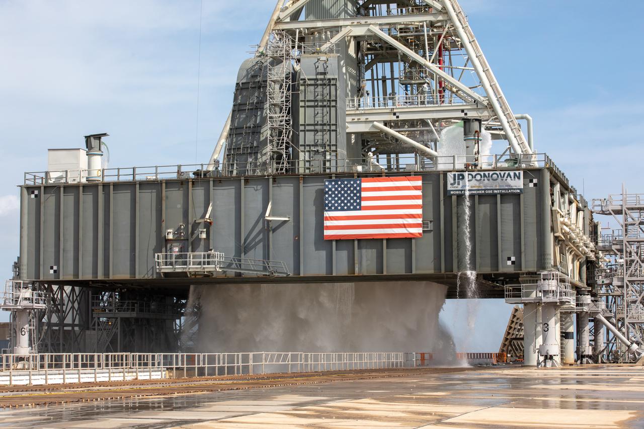 A wet flow test at Launch Pad 39B on September 13, 2019, tests the sound suppression system that will be used for launch of NASA’s Space Launch System for the Artemis I mission. During the test, about 450,000 gallons of water poured onto the Pad B flame deflector, the mobile launcher flame hole and onto the launcher’s blast deck. This was the first time the ground launch sequencer that will be used on the day of launch was used for the timing of a sound suppression test.