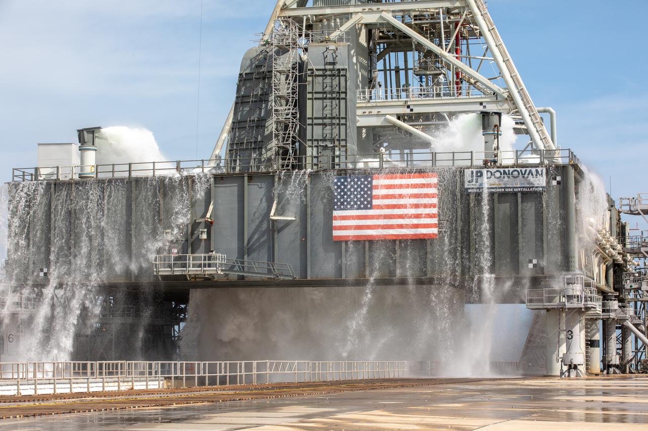 A wet flow test at Launch Pad 39B on September 13, 2019, tests the sound suppression system that will be used for launch of NASA’s Space Launch System for the Artemis I mission. During the test, about 450,000 gallons of water poured onto the Pad B flame deflector, the mobile launcher flame hole and onto the launcher’s blast deck. This was the first time the ground launch sequencer that will be used on the day of launch was used for the timing of a sound suppression test.