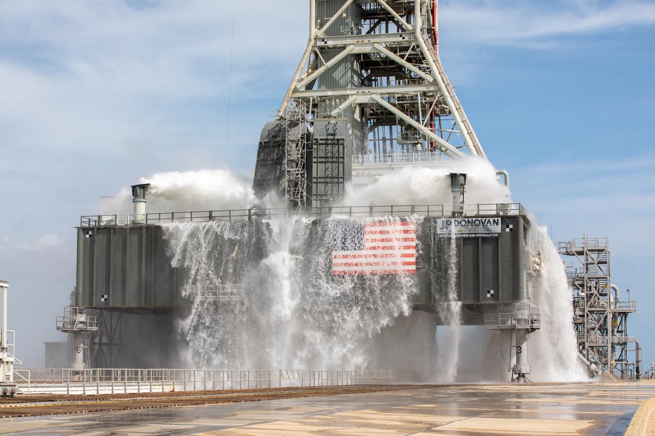A wet flow test at Launch Pad 39B on September 13, 2019, tests the sound suppression system that will be used for launch of NASA’s Space Launch System for the Artemis I mission. During the test, about 450,000 gallons of water poured onto the Pad B flame deflector, the mobile launcher flame hole and onto the launcher’s blast deck. This was the first time the ground launch sequencer that will be used on the day of launch was used for the timing of a sound suppression test.
