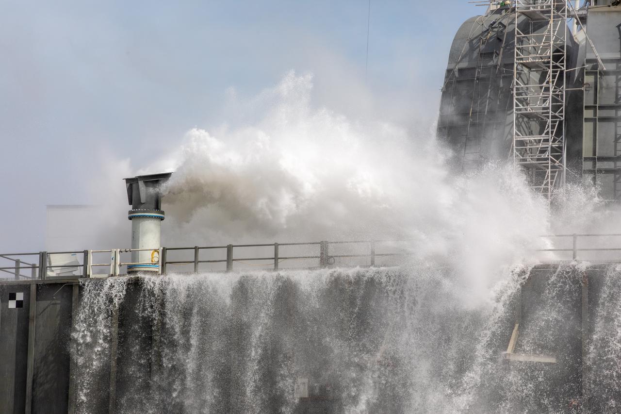 A wet flow test at Launch Pad 39B on September 13, 2019, tests the sound suppression system that will be used for launch of NASA’s Space Launch System for the Artemis I mission. During the test, about 450,000 gallons of water poured onto the Pad B flame deflector, the mobile launcher flame hole and onto the launcher’s blast deck. This was the first time the ground launch sequencer that will be used on the day of launch was used for the timing of a sound suppression test.