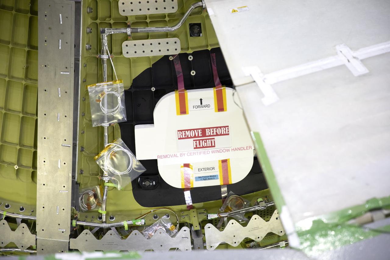 A close-up view of a cover over one of the windows on the Orion pressure vessel for NASA’s Artemis ll mission inside the Neil Armstrong Operations and Checkout Building high bay on Sept. 17, 2019. Orion is being prepared for the first crewed test flight atop the agency’s Space Launch System rocket. Artemis ll will lift off from Launch Complex 39B. The mission will confirm all of the spacecraft’s systems operate as designed in the actual environment of deep space with astronauts aboard.