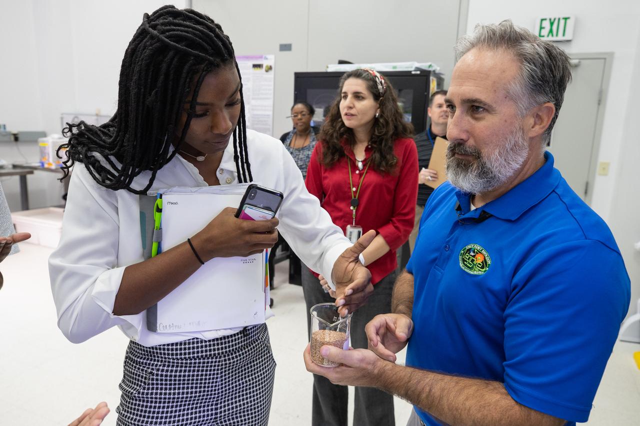 Langston University student Courtney Miller, left, interacts with Kennedy Space Center Veggie Project Manager Trent Smith inside a Space Station Processing Facility lab at Kennedy on Sept. 18, 2019. Behind them is Veggie Project lead Dr. Gioia Massa. Miller was one of four Langston students, along with professor Byron Quinn, Ph.D., who toured the Florida spaceport. The visit included stops at SwampWorks, the Neil Armstrong Operations and Checkout Building, the Vehicle Assembly Building, the visitor complex and the Center for Space Education.