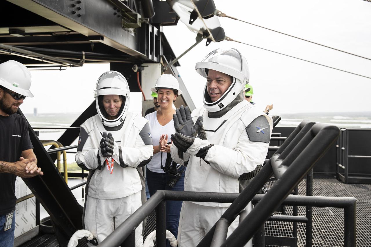 NASA and SpaceX conducted a formal verification of the company’s emergency escape system on Sept. 18, 2019, at Kennedy Space Center’s Launch Complex 39A in Florida. From left, NASA astronauts Shannon Walker and Bob Behnken participated in the exercise to verify the crew can safely and quickly evacuate from the launch pad in the unlikely event of an emergency before liftoff of SpaceX’s first crewed flight test, called Demo-2. At tower level on the pad, Walker and Behnken practiced loading into slidewire baskets and simulating an emergency escape to ground level. As Boeing and SpaceX begin to make regular flights to the International Space Station for NASA’s Commercial Crew Program, the agency will continue to advance its mission to go beyond low-Earth orbit and establish a human presence on the Moon with the ultimate goal of sending astronauts to Mars.