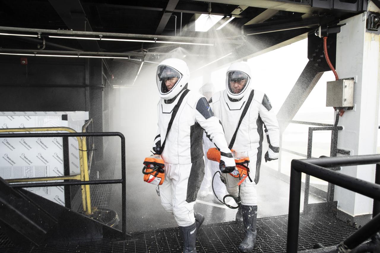 NASA and SpaceX conducted a formal verification of the company’s emergency escape system on Sept. 18, 2019, at Kennedy Space Center’s Launch Complex 39A in Florida. NASA astronauts Shannon Walker, in front, and Bob Behnken participated in the exercise to verify the crew can safely and quickly evacuate from the launch pad in the unlikely event of an emergency before liftoff of SpaceX’s first crewed flight test, called Demo-2. During the escape verification, Walker and Behnken pass through the water deluge system on the 265-foot level of the crew access tower. As Boeing and SpaceX begin to make regular flights to the International Space Station for NASA’s Commercial Crew Program, the agency will continue to advance its mission to go beyond low-Earth orbit and establish a human presence on the Moon with the ultimate goal of sending astronauts to Mars.