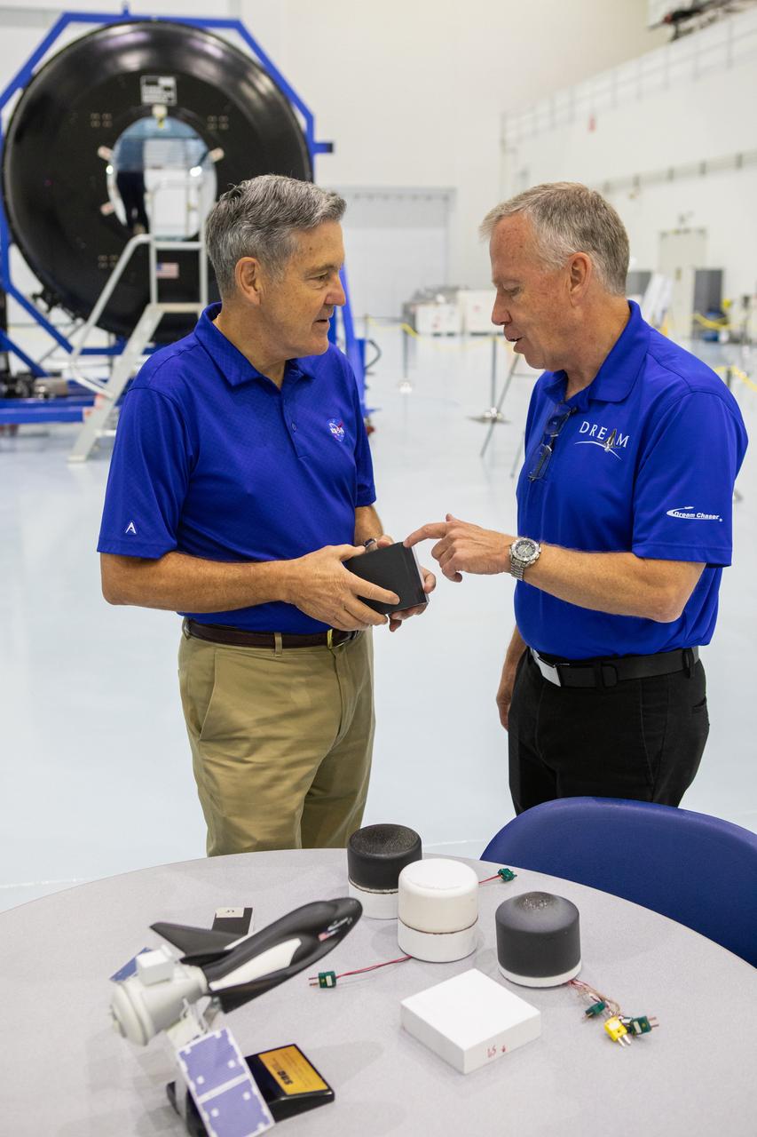 A mockup of the cargo logistics module for Sierra Nevada Corporation’s Dream Chaser, the company’s reusable spaceplane, arrived at the Space Station Processing Facility (SSPF) at NASA’s Kennedy Space Center in Florida in August. On Sept. 20, 2019, senior leadership had the opportunity to view the cargo module in the SSPF high bay. Kennedy Center Director Bob Cabana, left, speaks to Steve Lindsey, vice president, Space Exploration Systems, Sierra Nevada Corporation. The SSPF is providing support for current and future NASA and commercial provider programs, including Commercial Resupply Services, Artemis 1, sending the first woman and next man to the Moon, and deep space destinations including Mars.