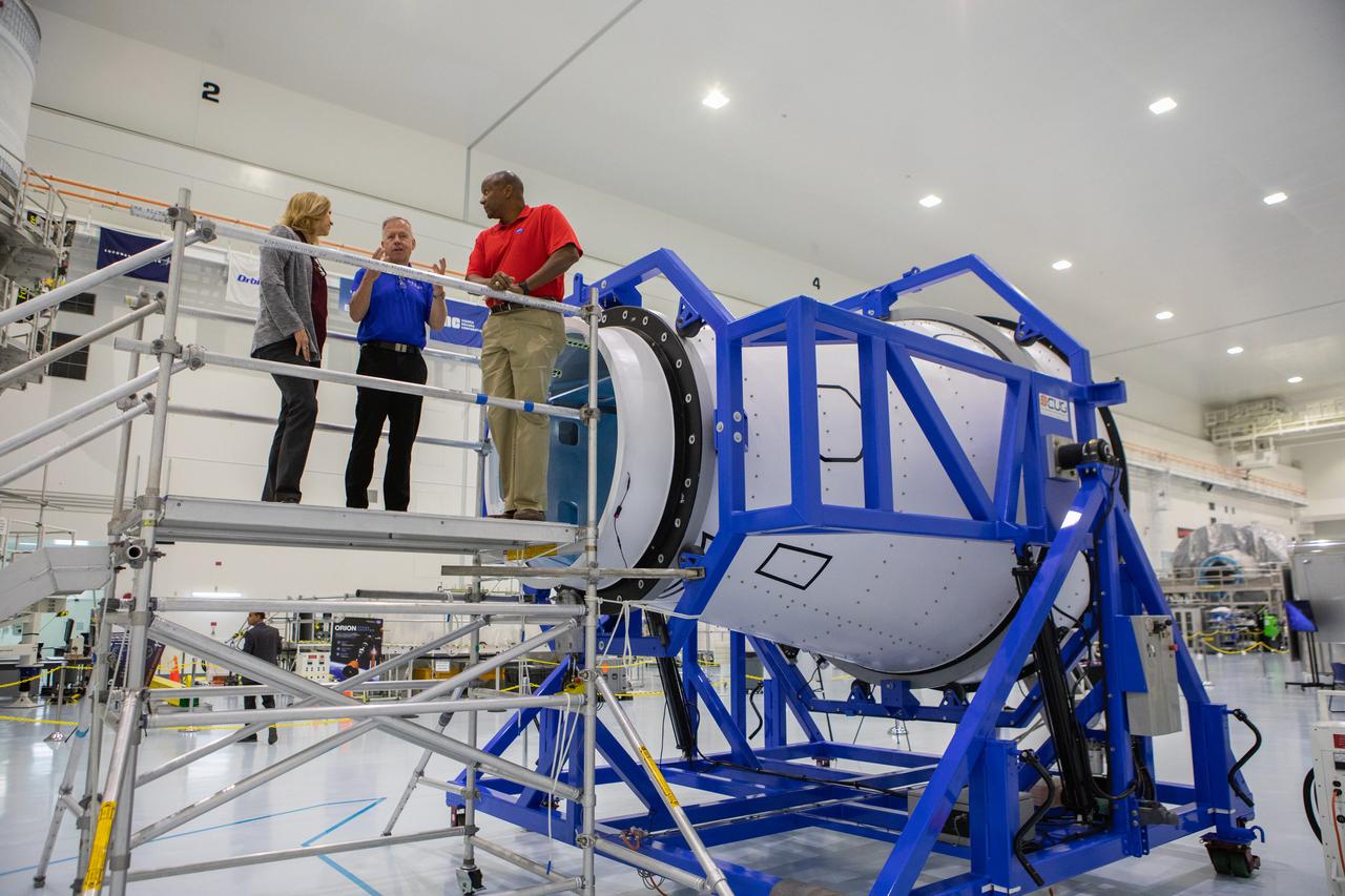 A mockup of the cargo logistics module for Sierra Nevada Corporation’s Dream Chaser, the company’s reusable spaceplane, arrived at the Space Station Processing Facility (SSPF) at NASA’s Kennedy Space Center in Florida in August. On Sept. 20, 2019, senior leadership had the opportunity to view the cargo module in the SSPF high bay. From left are Kennedy Deputy Director Janet Petro; Steve Lindsey, vice president, Space Exploration Systems, Sierra Nevada Corporation; and Kelvin Manning, Kennedy associate director, technical. The SSPF is providing support for current and future NASA and commercial provider programs, including Commercial Resupply Services, Artemis 1, sending the first woman and next man to the Moon, and deep space destinations including Mars.