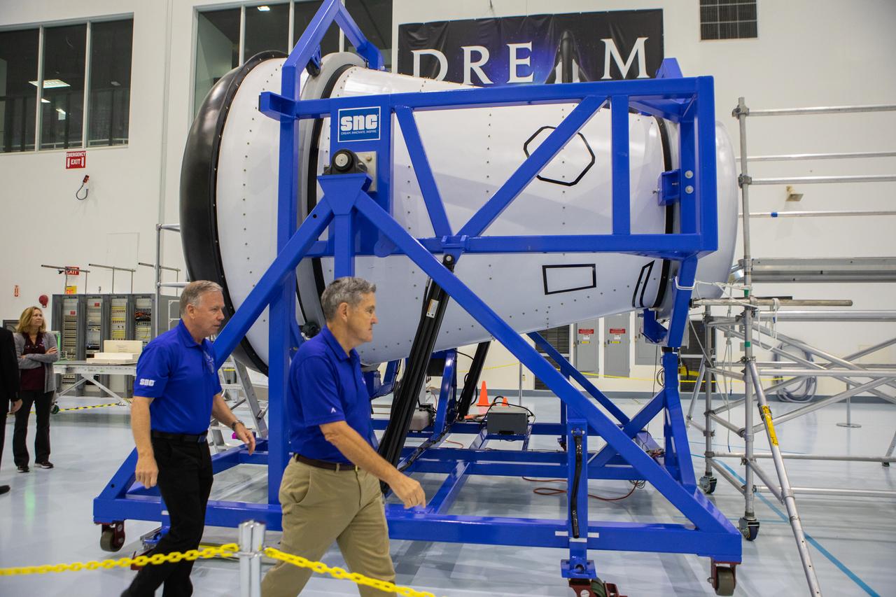 A mockup of the cargo logistics module for Sierra Nevada Corporation’s Dream Chaser, the company’s reusable spaceplane, arrived at the Space Station Processing Facility (SSPF) at NASA’s Kennedy Space Center in Florida in August. On Sept. 20, 2019, senior leadership had the opportunity to view the cargo module in the SSPF high bay. Kennedy Center Director Bob Cabana, at right, views the cargo module with Steve Lindsey, vice president, Space Exploration Systems, Sierra Nevada Corporation. The SSPF is providing support for current and future NASA and commercial provider programs, including Commercial Resupply Services, Artemis 1, sending the first woman and next man to the Moon, and deep space destinations including Mars.