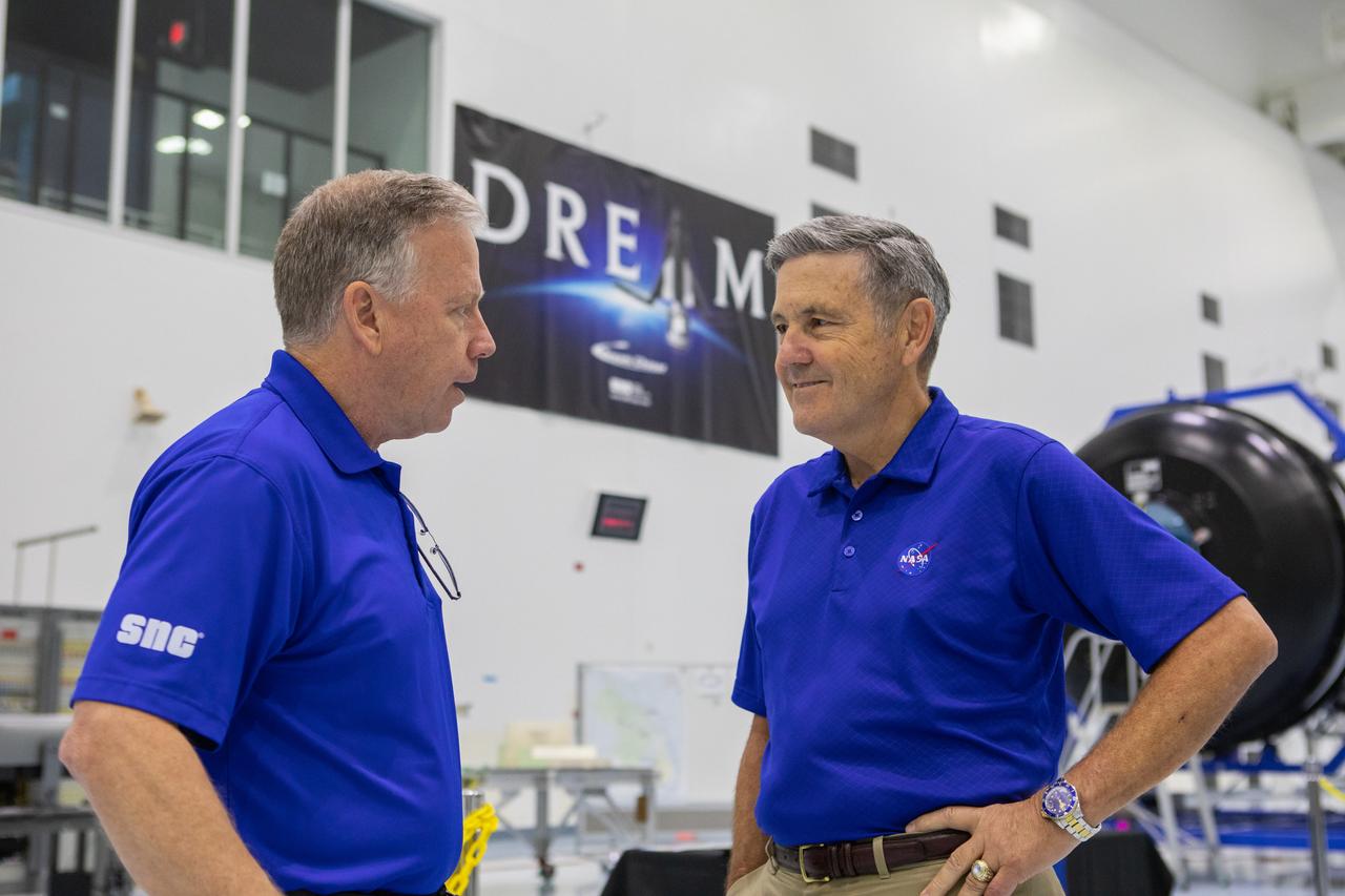 A mockup of the cargo logistics module for Sierra Nevada Corporation’s Dream Chaser, the company’s reusable spaceplane, arrived at the Space Station Processing Facility (SSPF) at NASA’s Kennedy Space Center in Florida in August. On Sept. 20, 2019, senior leadership had the opportunity to view the cargo module in the SSPF high bay. Kennedy Center Director Bob Cabana, at right, speaks with Steve Lindsey, vice president, Space Exploration Systems, Sierra Nevada Corporation. The SSPF is providing support for current and future NASA and commercial provider programs, including Commercial Resupply Services, Artemis 1, sending the first woman and next man to the Moon, and deep space destinations including Mars. 
