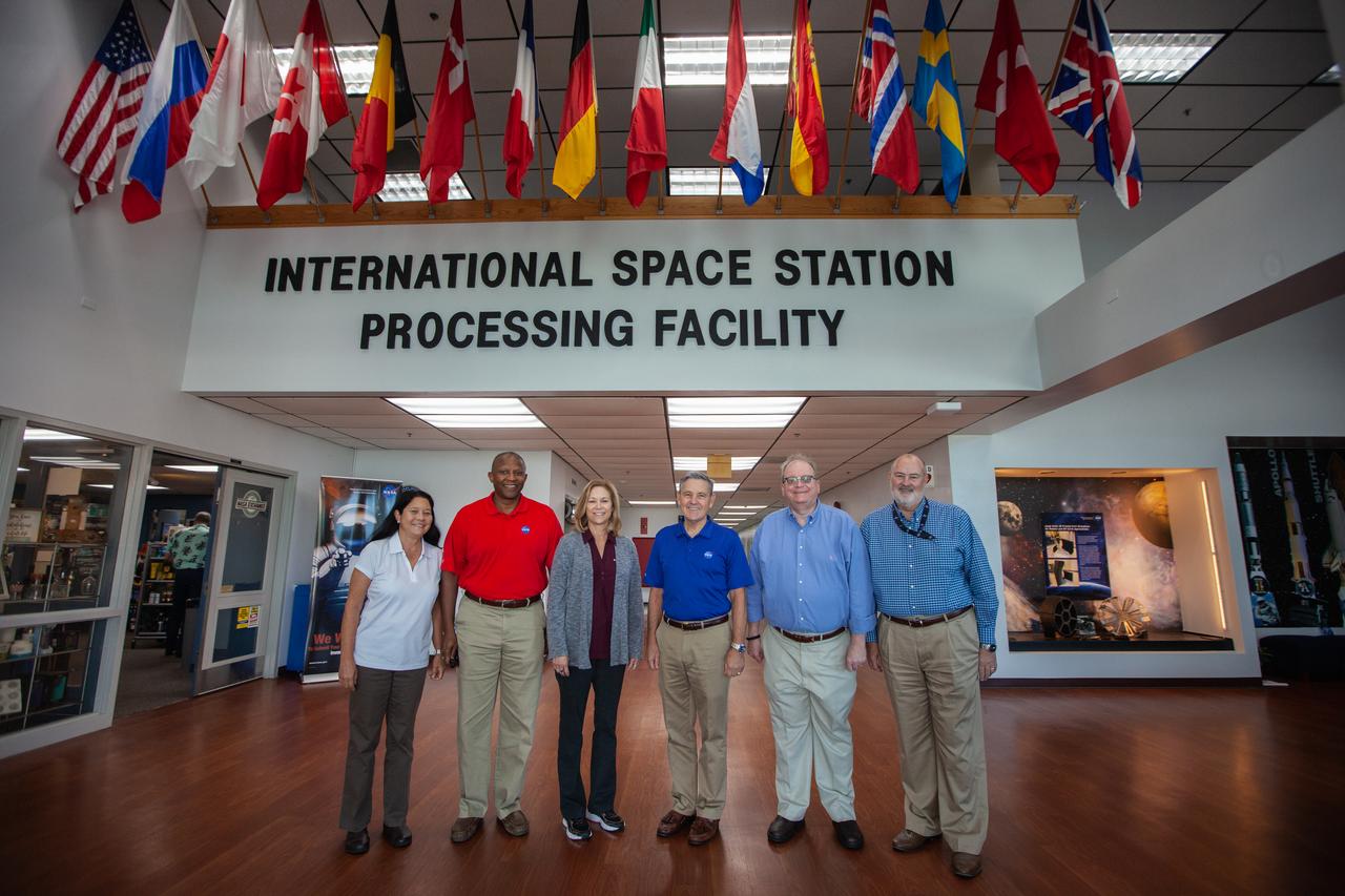 A mockup of the cargo logistics module for Sierra Nevada Corporation’s Dream Chaser, the company’s reusable spaceplane, arrived at the Space Station Processing Facility (SSPF) at NASA’s Kennedy Space Center in Florida in August. On Sept. 20, 2019, senior leadership had the opportunity to view the cargo module in the SSPF high bay. From left, are Josie Burnett, director of Exploration Research and Technology Programs; Kelvin Manning, Kennedy associate director, technical; Kennedy Deputy Director Janet Petro; Kennedy Center Director Bob Cabana; Burt Summerfield, Kennedy associate director, management; and Ronnie Lawson, deputy director of Exploration Research and Technology Programs. The SSPF is providing support for current and future NASA and commercial provider programs, including Commercial Resupply Services, Artemis 1, sending the first woman and next man to the Moon, and deep space destinations including Mars.
