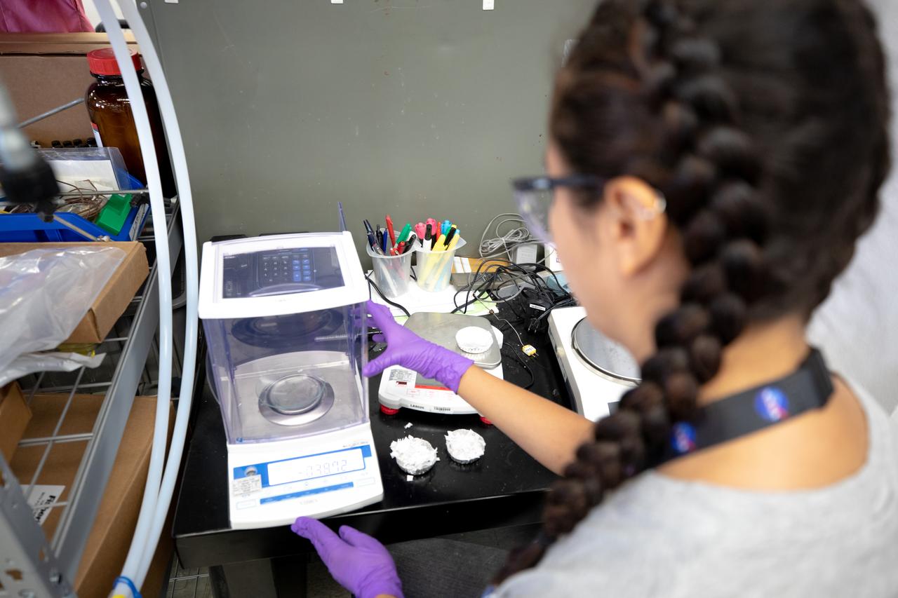 Isabella Aviles, an intern at NASA’s Kennedy Space Center in Florida, weighs trash simulant – comprised of different types of material that have been cut into tiny pieces – that will be utilized for the agency’s Orbital Syngas Commodity Augmentation Reactor, or OSCAR. OSCAR is an Early Career Initiative project at the Florida spaceport that studies technology to convert trash and human waste into useful gasses such as methane, hydrogen and carbon dioxide. By processing small pieces of trash in a high-temperature reactor, OSCAR is advancing new and innovative technology for managing waste in space. OSCAR would reduce the amount of space needed for waste storage within a spacecraft, turn some waste into gasses that have energy storage and life support applications, and ensure waste is no longer biologically active. A prototype has been developed, and a team of Kennedy employees are in the process of constructing a new rig for suborbital flight testing. 