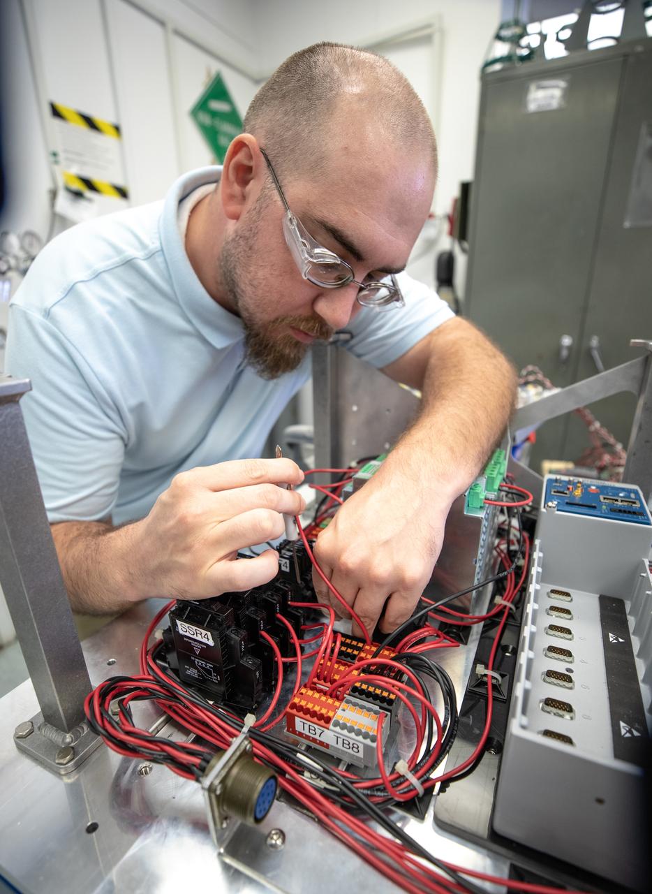 Thomas Cauvel, an intern assisting with software/electrical engineering on NASA’s Orbital Syngas Commodity Augmentation Reactor, or OSCAR, at Kennedy Space Center assembles the flight hardware. OSCAR is an Early Career Initiative project at the Florida spaceport that studies technology to convert trash and human waste into useful gasses such as methane, hydrogen and carbon dioxide. By processing small pieces of trash in a high-temperature reactor, OSCAR is advancing new and innovative technology for managing waste in space. OSCAR would reduce the amount of space needed for waste storage within a spacecraft, turn some waste into gasses that have energy storage and life support applications, and ensure waste is no longer biologically active. A prototype has been developed, and a team of Kennedy employees are in the process of constructing a new rig for suborbital flight testing. 