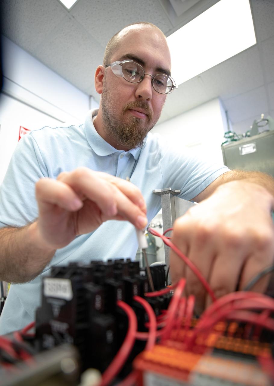 Thomas Cauvel, an intern assisting with software/electrical engineering on NASA’s Orbital Syngas Commodity Augmentation Reactor, or OSCAR, at Kennedy Space Center assembles the flight hardware. OSCAR is an Early Career Initiative project at the Florida spaceport that studies technology to convert trash and human waste into useful gasses such as methane, hydrogen and carbon dioxide. By processing small pieces of trash in a high-temperature reactor, OSCAR is advancing new and innovative technology for managing waste in space. OSCAR would reduce the amount of space needed for waste storage within a spacecraft, turn some waste into gasses that have energy storage and life support applications, and ensure waste is no longer biologically active. A prototype has been developed, and a team of Kennedy employees are in the process of constructing a new rig for suborbital flight testing. 