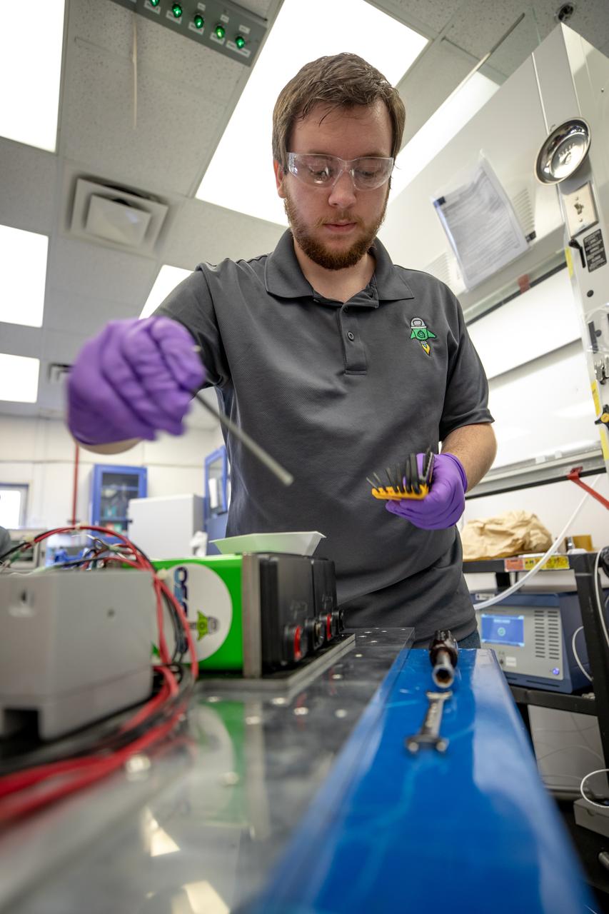 Jonathan Gleeson, Kennedy Space Center employee providing support for NASA’s Orbital Syngas Commodity Augmentation Reactor (OSCAR) under the center’s Laboratory Support Services and Operations contract, assembles the flight hardware of OSCAR. OSCAR is an Early Career Initiative project at the Florida spaceport that studies technology to convert trash and human waste into useful gasses such as methane, hydrogen and carbon dioxide. By processing small pieces of trash in a high-temperature reactor, OSCAR is advancing new and innovative technology for managing waste in space. OSCAR would reduce the amount of space needed for waste storage within a spacecraft, turn some waste into gasses that have energy storage and life support applications, and ensure waste is no longer biologically active. A prototype has been developed, and a team of Kennedy employees are in the process of constructing a new rig for suborbital flight testing. 
