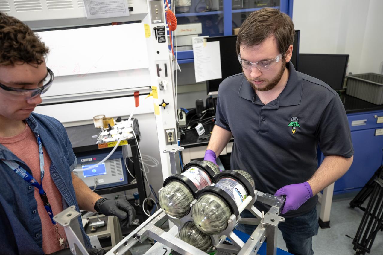 Kennedy Space Center employee Jonathan Gleeson (right) and Kennedy intern Patrick Follis assemble the flight hardware of NASA’s Orbital Syngas Commodity Augmentation Reactor, or OSCAR. OSCAR is an Early Career Initiative project at the Florida spaceport that studies technology to convert trash and human waste into useful gasses such as methane, hydrogen and carbon dioxide. By processing small pieces of trash in a high-temperature reactor, OSCAR is advancing new and innovative technology for managing waste in space. OSCAR would reduce the amount of space needed for waste storage within a spacecraft, turn some waste into gasses that have energy storage and life support applications, and ensure waste is no longer biologically active. A prototype has been developed, and a team of Kennedy employees are in the process of constructing a new rig for suborbital flight testing.