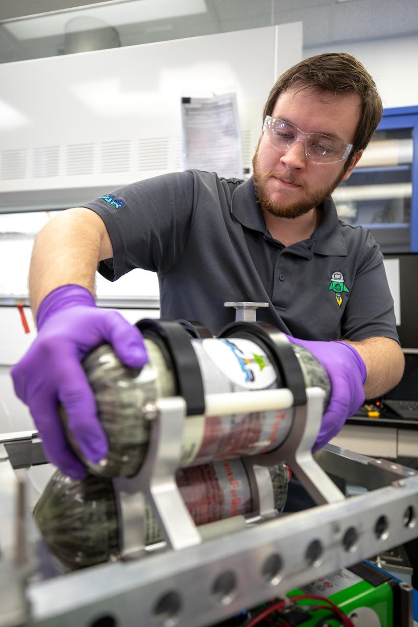 Jonathan Gleeson, Kennedy Space Center employee providing support for NASA’s Orbital Syngas Commodity Augmentation Reactor (OSCAR) under the center’s Laboratory Support Services and Operations contract, installs OSCAR to the flight hardware that will carry it on its suborbital flight test. OSCAR is an Early Career Initiative project at the Florida spaceport that studies technology to convert trash and human waste into useful gasses such as methane, hydrogen and carbon dioxide. By processing small pieces of trash in a high-temperature reactor, OSCAR is advancing new and innovative technology for managing waste in space. OSCAR would reduce the amount of space needed for waste storage within a spacecraft, turn some waste into gasses that have energy storage and life support applications, and ensure waste is no longer biologically active. A prototype has been developed, and a team of Kennedy employees have worked on constructing a new rig for suborbital flight testing. 