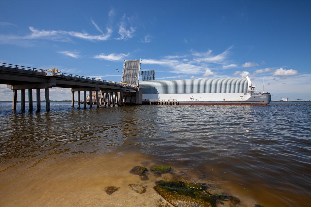 NASA's Pegasus Barge makes its way along the intercoastal waterway to its destination at the Kennedy Space Center Launch Complex 39 turn basin wharf, to make its first delivery to Kennedy in support of the agency's Artemis missions. The upgraded 310-foot-long barge arrived Sept. 27, 2019, ferrying the 212-foot-long Space Launch System rocket core stage pathfinder. The pathfinder is a full-scale mock-up of the rocket's core stage. The pathfinder will be used by the Exploration Ground Systems Program and their contractor, Jacobs, to practice offloading, moving and stacking maneuvers, using important ground support equipment to train employees and certify all the equipment works properly. The pathfinder will stay at Kennedy for approximately one month before trekking back to NASA's Michoud Assembly Facility in Louisiana.