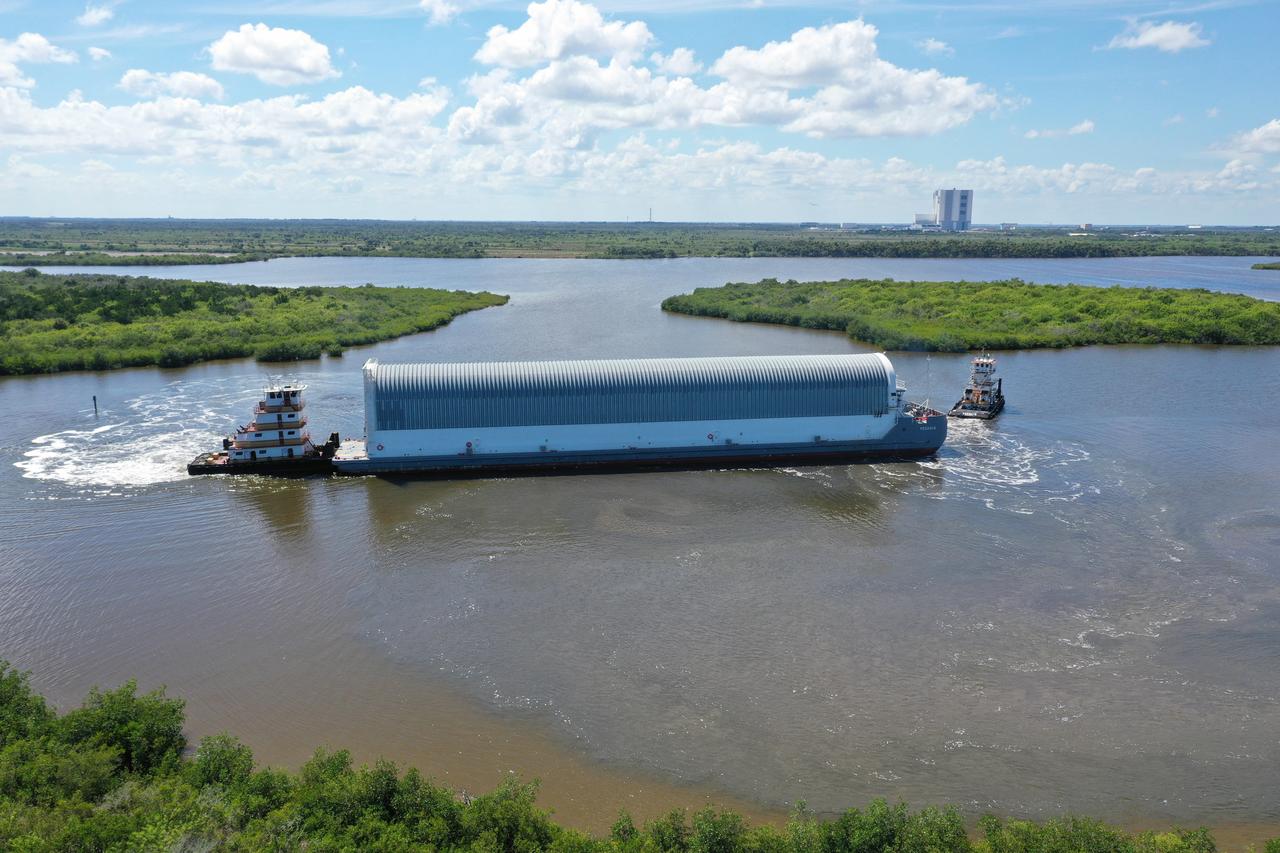 NASA's Pegasus Barge makes its way along the intercoastal waterway to its destination at the Kennedy Space Center Launch Complex 39 turn basin wharf, to make its first delivery to Kennedy in support of the agency's Artemis missions. The upgraded 310-foot-long barge arrived Sept. 27, 2019, ferrying the 212-foot-long Space Launch System rocket core stage pathfinder. The pathfinder is a full-scale mock-up of the rocket's core stage. The pathfinder will be used by the Exploration Ground Systems Program and their contractor, Jacobs, to practice offloading, moving and stacking maneuvers, using important ground support equipment to train employees and certify all the equipment works properly. The pathfinder will stay at Kennedy for approximately one month before trekking back to NASA's Michoud Assembly Facility in Louisiana.