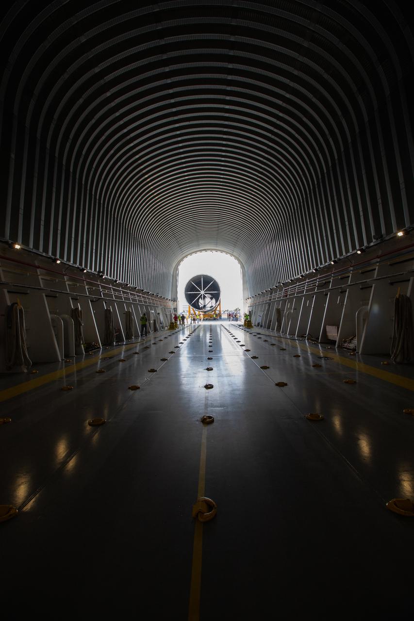 In this view from inside NASA’s Pegasus Barge, the 212-foot-long Space Launch System (SLS) rocket core stage pathfinder is being offloaded from the barge at Kennedy Space Center’s Launch Complex 39 turn basin wharf on Sept. 30, 2019. The Pegasus Barge made its first delivery to Kennedy in support of the agency's Artemis missions. The upgraded 310-foot-long barge arrived Sept. 27, 2019, ferrying the SLS core stage pathfinder, a full-scale mock-up of the rocket's core stage. It will be used by the Exploration Ground Systems Program and their contractor, Jacobs, to practice offloading, moving and stacking maneuvers, using important ground support equipment to train employees and certify all the equipment works properly. The pathfinder will stay at Kennedy for approximately one month before trekking back to NASA's Michoud Assembly Facility in Louisiana.