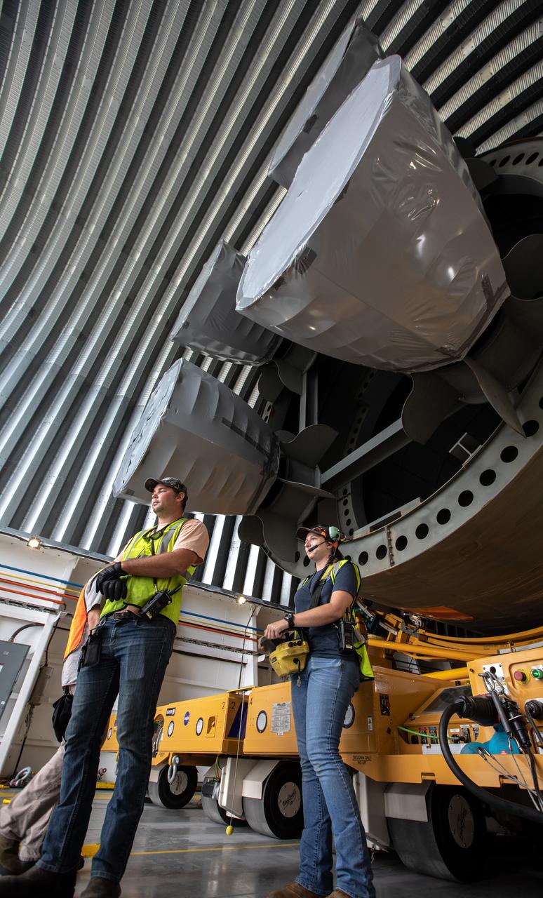 Jacobs TOSC Launch Vehicle Technical Operations technicians begin offloading of the 212-foot-long Space Launch System (SLS) rocket core stage pathfinder from NASA's Pegasus Barge at Kennedy Space Center’s Launch Complex 39 turn basin wharf on Oct. 1, 2019. From left, are James Erdman, observer, and Katherine River, operator. The Pegasus Barge made its first delivery to Kennedy in support of the agency's Artemis missions. The upgraded 310-foot-long barge arrived Sept. 27, 2019, ferrying the SLS core stage pathfinder, a full-scale mock-up of the rocket's core stage. It will be used by Exploration Ground Systems and its contractor, Jacobs, to practice offloading, moving and stacking maneuvers, using important ground support equipment to train employees and certify all the equipment works properly. The pathfinder will stay at Kennedy for approximately one month before trekking back to NASA's Michoud Assembly Facility in Louisiana.