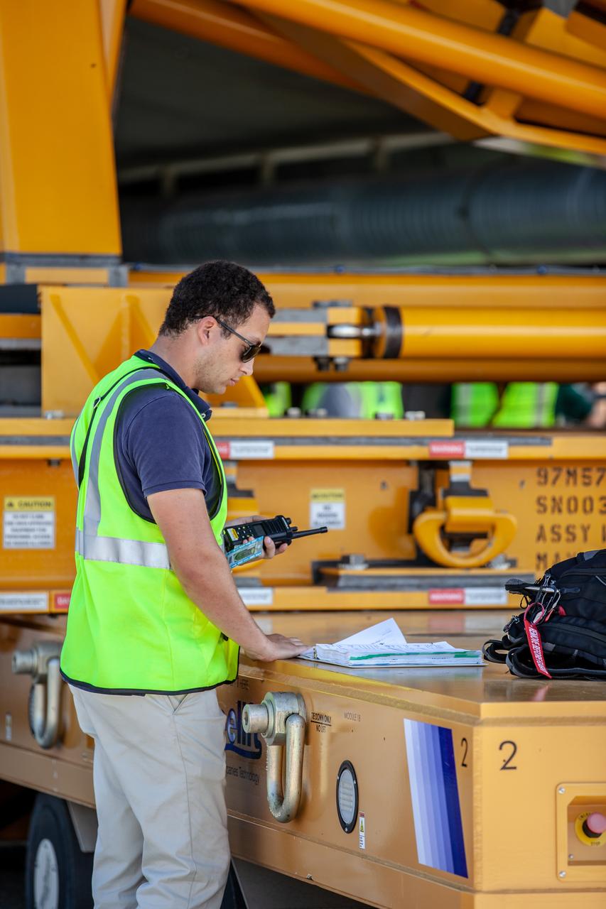 Chris Di Taranto, a mechanical and structures engineer with Jacobs TOSC, prepares for offloading of the 212-foot-long Space Launch System (SLS) rocket core stage pathfinder from NASA’s Pegasus Barge at Kennedy Space Center’s Launch Complex 39 turn basin wharf on Oct. 1, 2019. The Pegasus Barge made its first delivery to Kennedy in support of the agency's Artemis missions. The upgraded 310-foot-long barge arrived Sept. 27, 2019, ferrying the SLS core stage pathfinder, a full-scale mock-up of the rocket's core stage. It will be used by Exploration Ground Systems and its contractor, Jacobs, to practice offloading, moving and stacking maneuvers, using important ground support equipment to train employees and certify all the equipment works properly. The pathfinder will stay at Kennedy for approximately one month before trekking back to NASA's Michoud Assembly Facility in Louisiana.