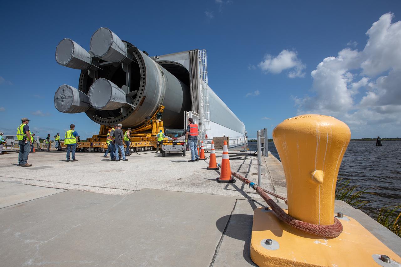 The 212-foot-long Space Launch System (SLS) rocket core stage pathfinder is being offloaded from the barge at Kennedy Space Center’s Launch Complex 39 turn basin wharf on Oct. 1, 2019. The Pegasus Barge made its first delivery to Kennedy in support of the agency's Artemis missions. The upgraded 310-foot-long barge arrived Sept. 27, 2019, ferrying the SLS core stage pathfinder, a full-scale mock-up of the rocket's core stage. It is being used by Exploration Ground Systems and its, Jacobs, to practice offloading, moving and stacking maneuvers, using important ground support equipment to train employees and certify all the equipment works properly. The pathfinder will stay at Kennedy for approximately one month before trekking back to NASA's Michoud Assembly Facility in Louisiana.