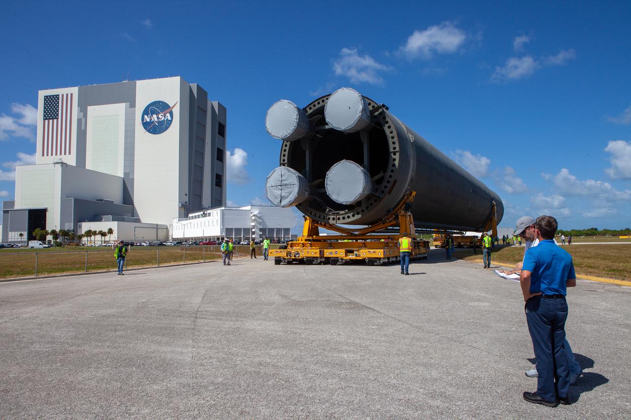 The 212-foot-long Space Launch System (SLS) rocket core stage pathfinder has been offloaded from NASA’s Pegasus Barge at Kennedy Space Center’s Launch Complex 39 turn basin wharf on Oct. 1, 2019. It is slowly being backed up so that it is in the correct configuration for the move forward to the Vehicle Assembly Building. The Pegasus Barge made its first delivery to Kennedy in support of the agency's Artemis missions. The upgraded 310-foot-long barge arrived Sept. 27, 2019, ferrying the SLS core stage pathfinder, a full-scale mock-up of the rocket's core stage. It will be used by Exploration Ground Systems and its contractor, Jacobs, to practice offloading, moving and stacking maneuvers, using important ground support equipment to train employees and certify all the equipment works properly. The pathfinder will stay at Kennedy for approximately one month before trekking back to NASA's Michoud Assembly Facility in Louisiana.