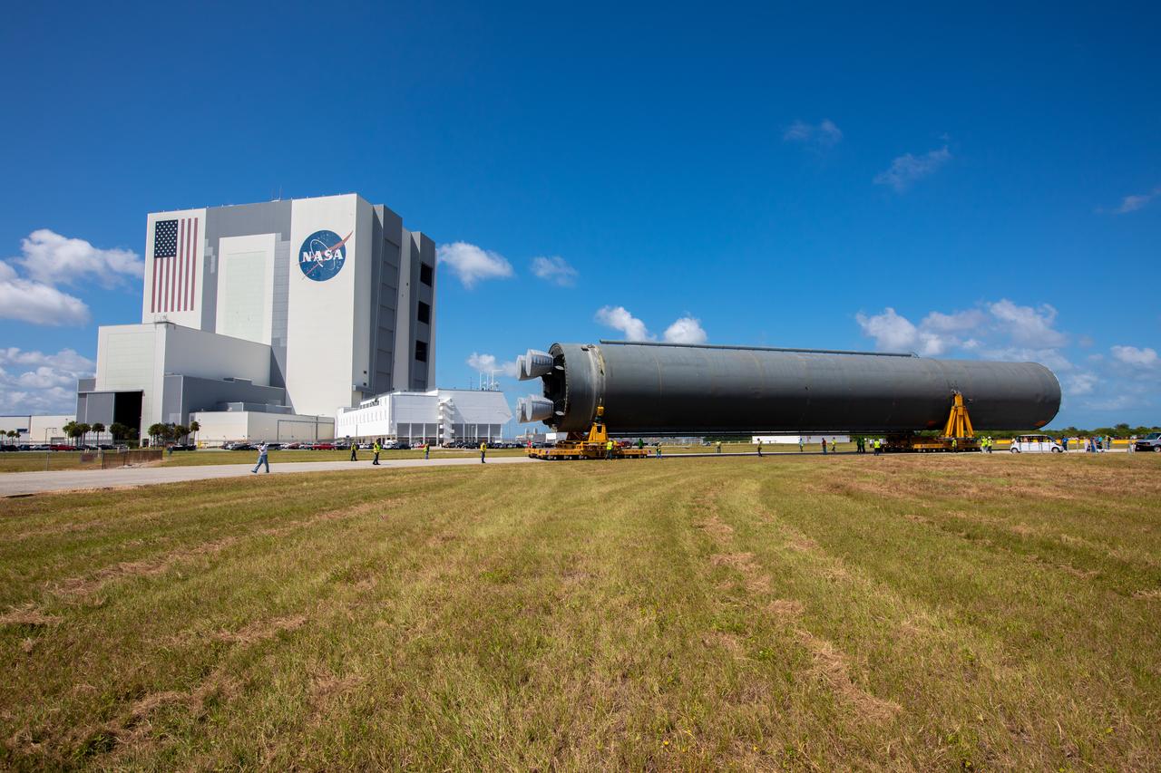 The 212-foot-long Space Launch System (SLS) rocket core stage pathfinder has been offloaded from NASA’s Pegasus Barge at Kennedy Space Center’s Launch Complex 39 turn basin wharf on Oct. 1, 2019. It is slowly being backed up so that it is in the correct configuration for the move forward to the Vehicle Assembly Building. The Pegasus Barge made its first delivery to Kennedy in support of the agency's Artemis missions. The upgraded 310-foot-long barge arrived Sept. 27, 2019, ferrying the SLS core stage pathfinder, a full-scale mock-up of the rocket's core stage. It will be used by Exploration Ground Systems and its contractor, Jacobs, to practice offloading, moving and stacking maneuvers, using important ground support equipment to train employees and certify all the equipment works properly. The pathfinder will stay at Kennedy for approximately one month before trekking back to NASA's Michoud Assembly Facility in Louisiana.
