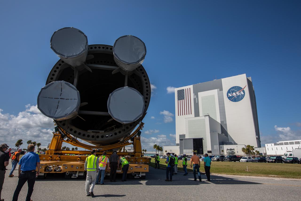 The 212-foot-long Space Launch System (SLS) rocket core stage pathfinder is being transported to the Vehicle Assembly Building at NASA’s Kennedy Space Center in Florida on Oct. 1, 2019. NASA's Pegasus Barge arrived at the Launch Complex 39 turn basin wharf on Sept. 30, 2019, making its first delivery to Kennedy in support of the agency's Artemis missions. The upgraded 310-foot-long barge arrived Sept. 27, 2019, ferrying the SLS core stage pathfinder, a full-scale mock-up of the rocket's core stage. The pathfinder will be used by the Exploration Ground Systems Program and their contractor, Jacobs, to practice offloading, moving and stacking maneuvers, using important ground support equipment to train employees and certify all the equipment works properly. The pathfinder will stay at Kennedy for approximately one month before trekking back to NASA's Michoud Assembly Facility in Louisiana.